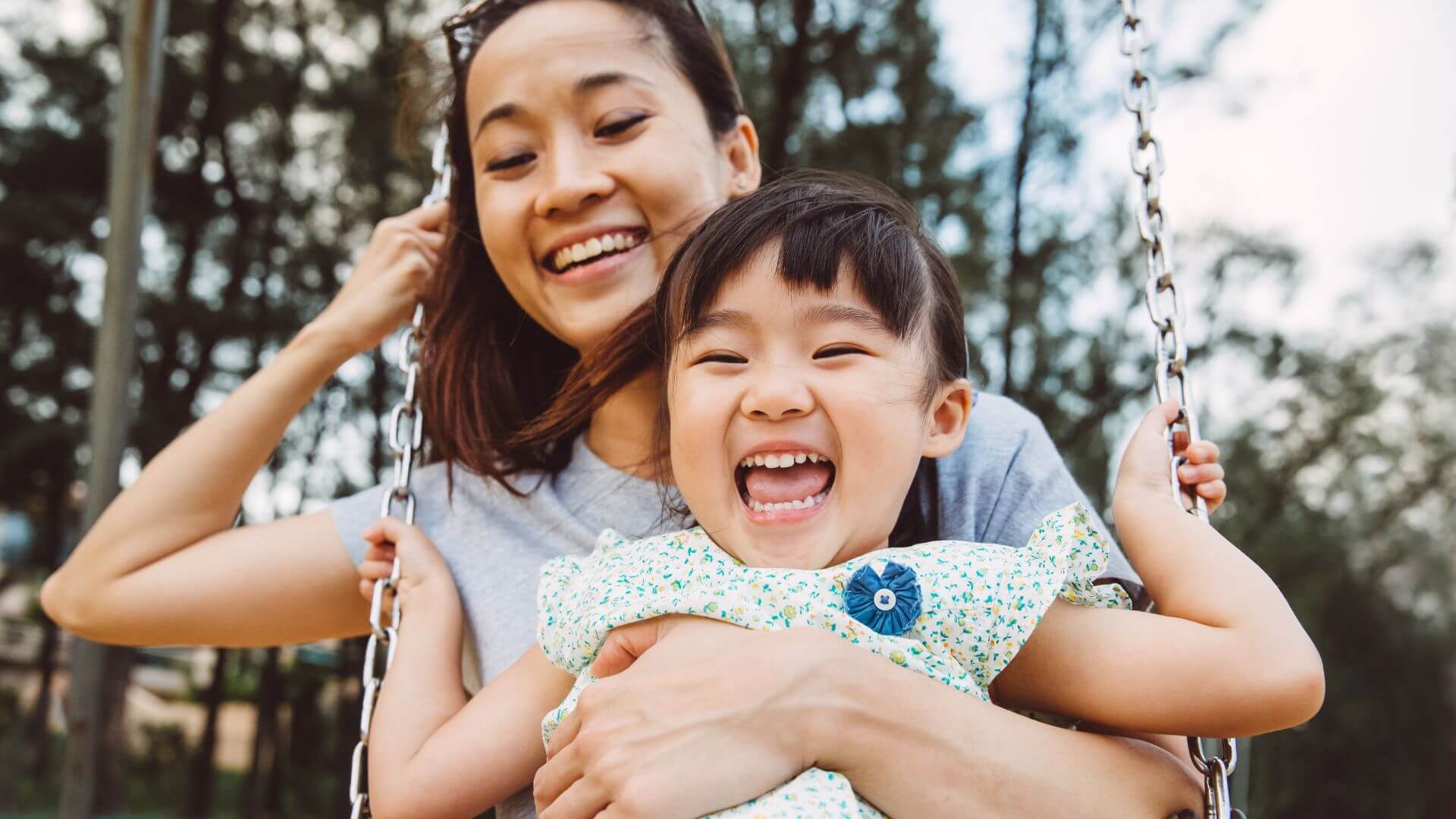 NDIS experience with plan management services- Mom & toddler swinging on swing joyfully in park